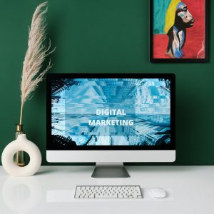 A contemporary office desk with computer screen showcasing digital marketing content.